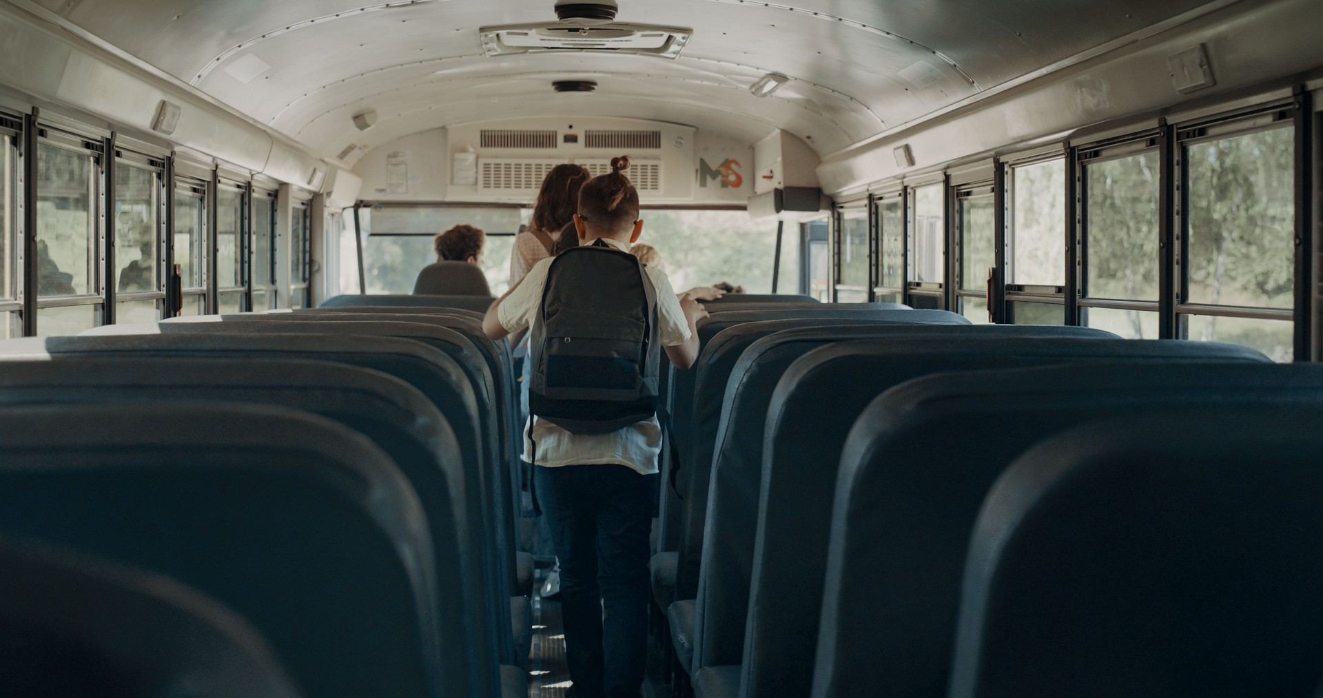 Energetic pupils leave academic shuttle. Friendly crowd go out schoolbus.